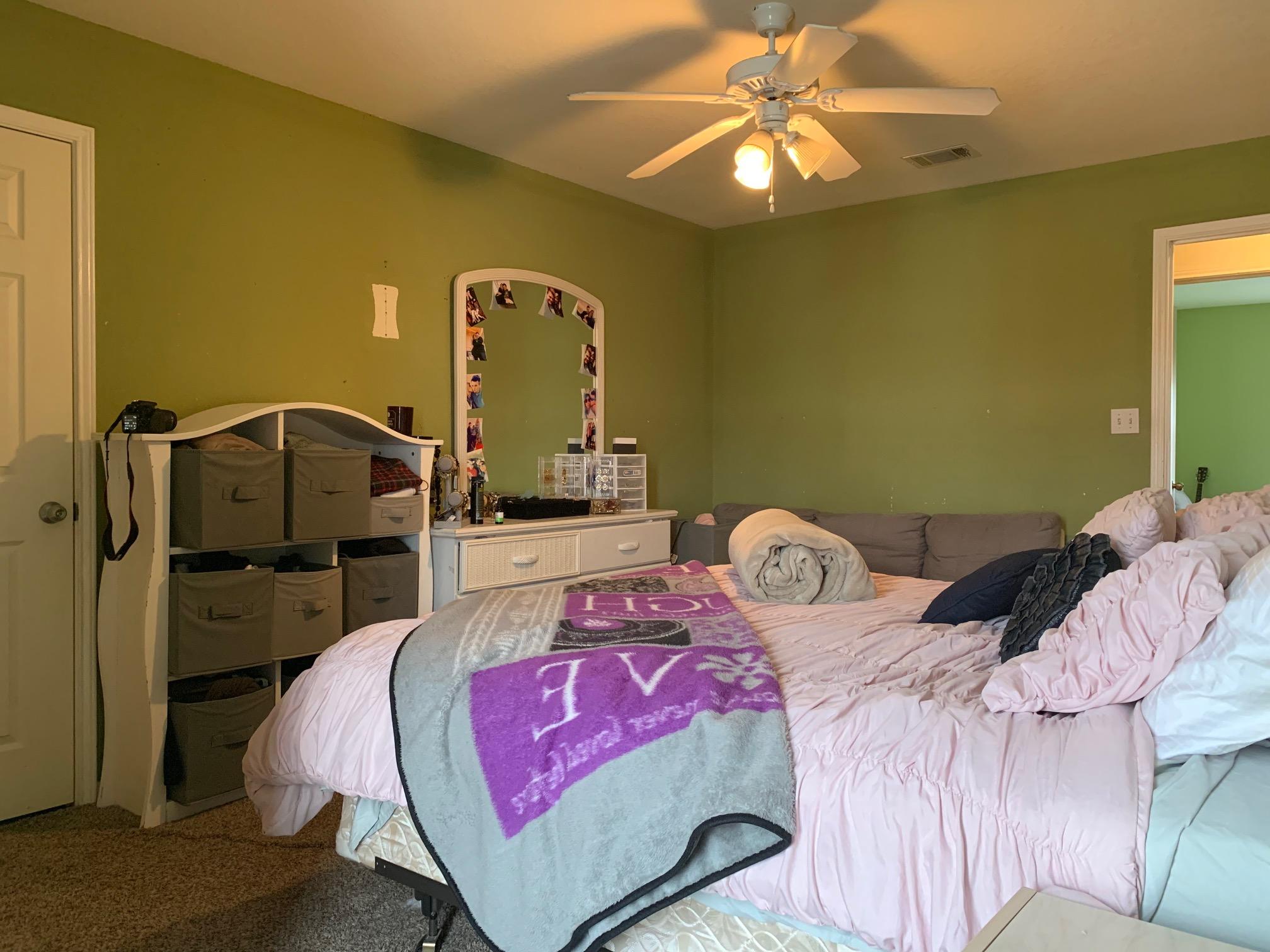 1014 Airport Road, Unit 114 Destin, FL 32541 - Photo 9 of 15 a bedroom with a bed and a chandelier
