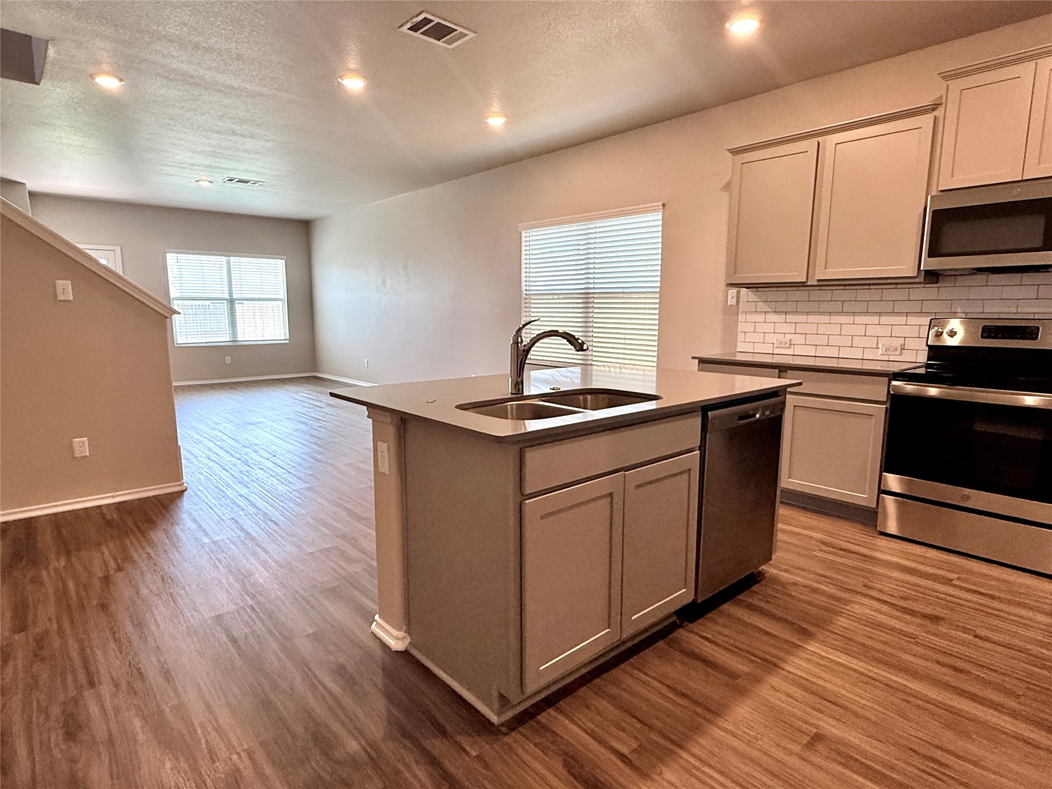 129 Perfect World Loop Jarrell, TX 76537 - Photo 30 of 31 An open floorplan seamlessly connects the well-appointed kitchen to the adjacent living spaces.