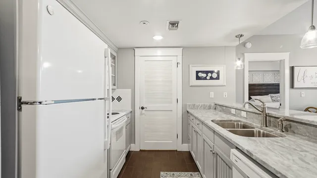a kitchen with stainless steel appliances granite countertop a sink refrigerator and cabinets
