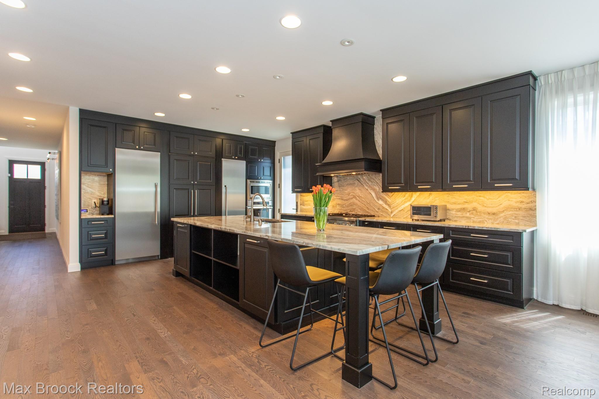 25925 York Road Royal Oak, MI 48067 - Photo 9 of 88 Kitchen featuring light stone counters, an island with sink, stainless steel built in refrigerator, dark wood-style floors, and recessed lighting