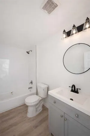 a bathroom with a sink a toilet and a mirror