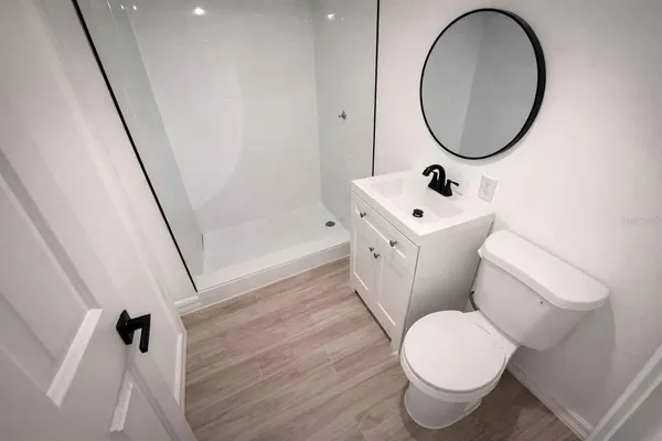 a bathroom with a sink toilet and a mirror
