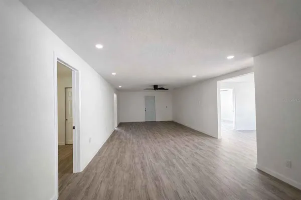 a view of a room with wooden floor and window