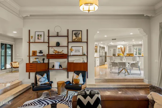 a living room with furniture and a bookshelf