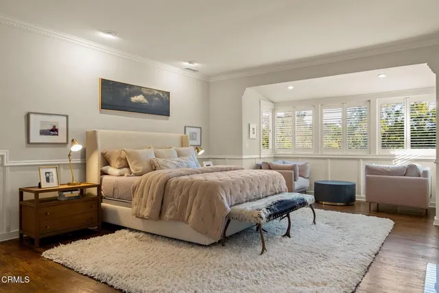 a view of a yard with plants and large trees