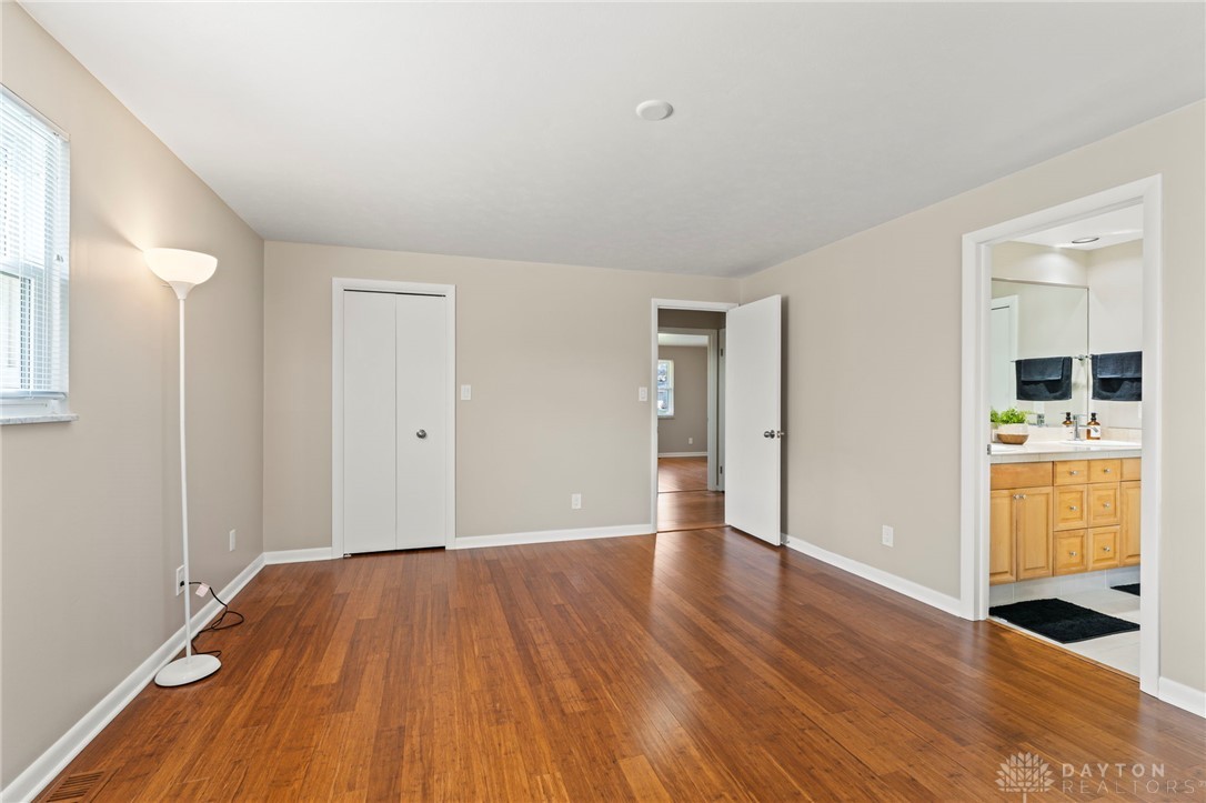 2247 East Whipp Road Dayton, OH 45440 - Photo 26 of 52 Bright and airy, this bedroom features rich hardwood flooring and a convenient attached bathroom.