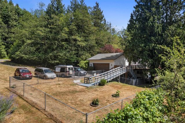 a view of a patio with table and chairs potted plants with wooden fence