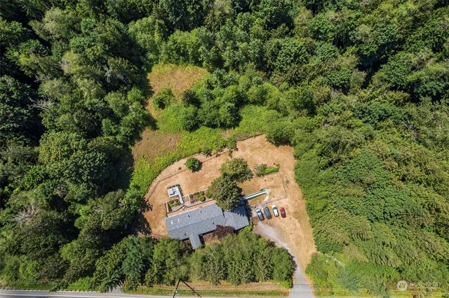 an aerial view of a house with a yard and lake view