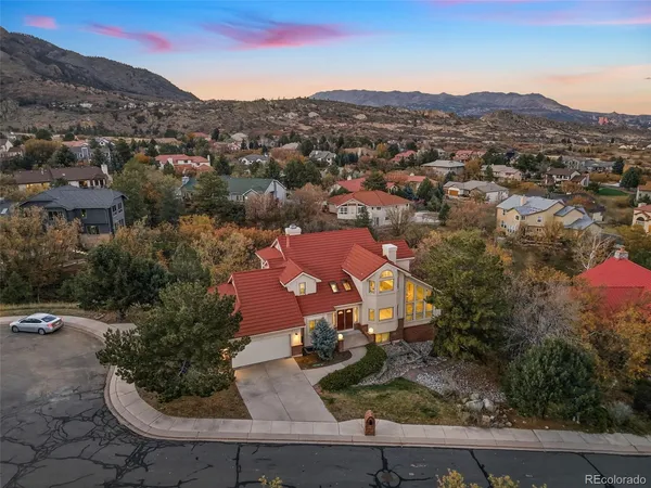 an aerial view of residential houses with outdoor space and trees
