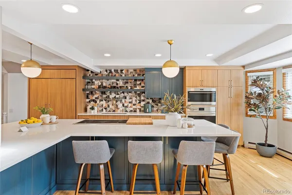 a large kitchen with a table and chairs