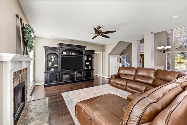 a bedroom with a large bed and a chandelier fan