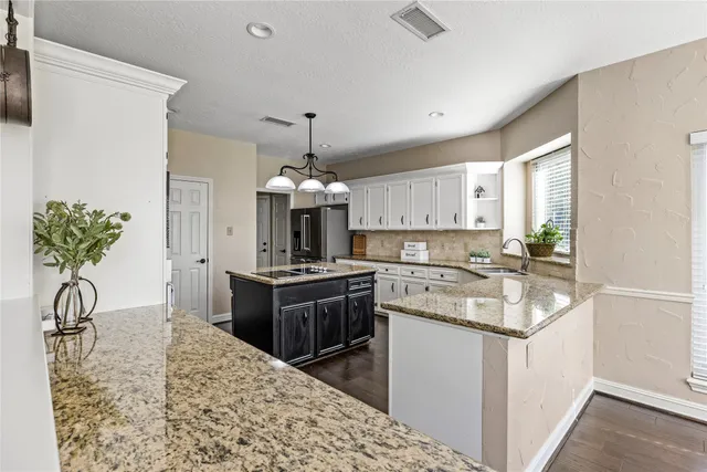 a bathroom with a granite countertop sink mirror and bathtub