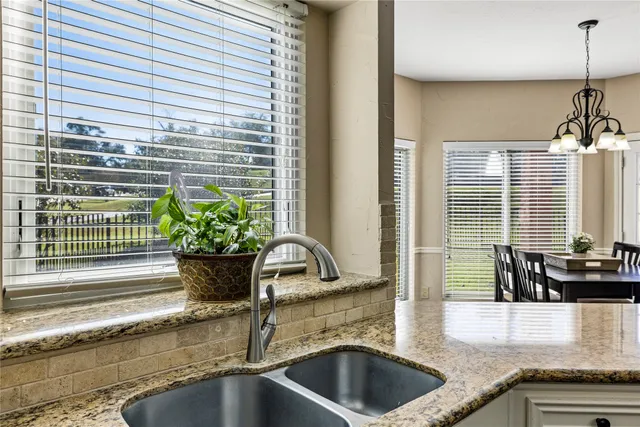 a room with pool table table and window