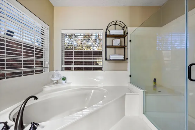 a spacious bedroom with a bed and a chandelier