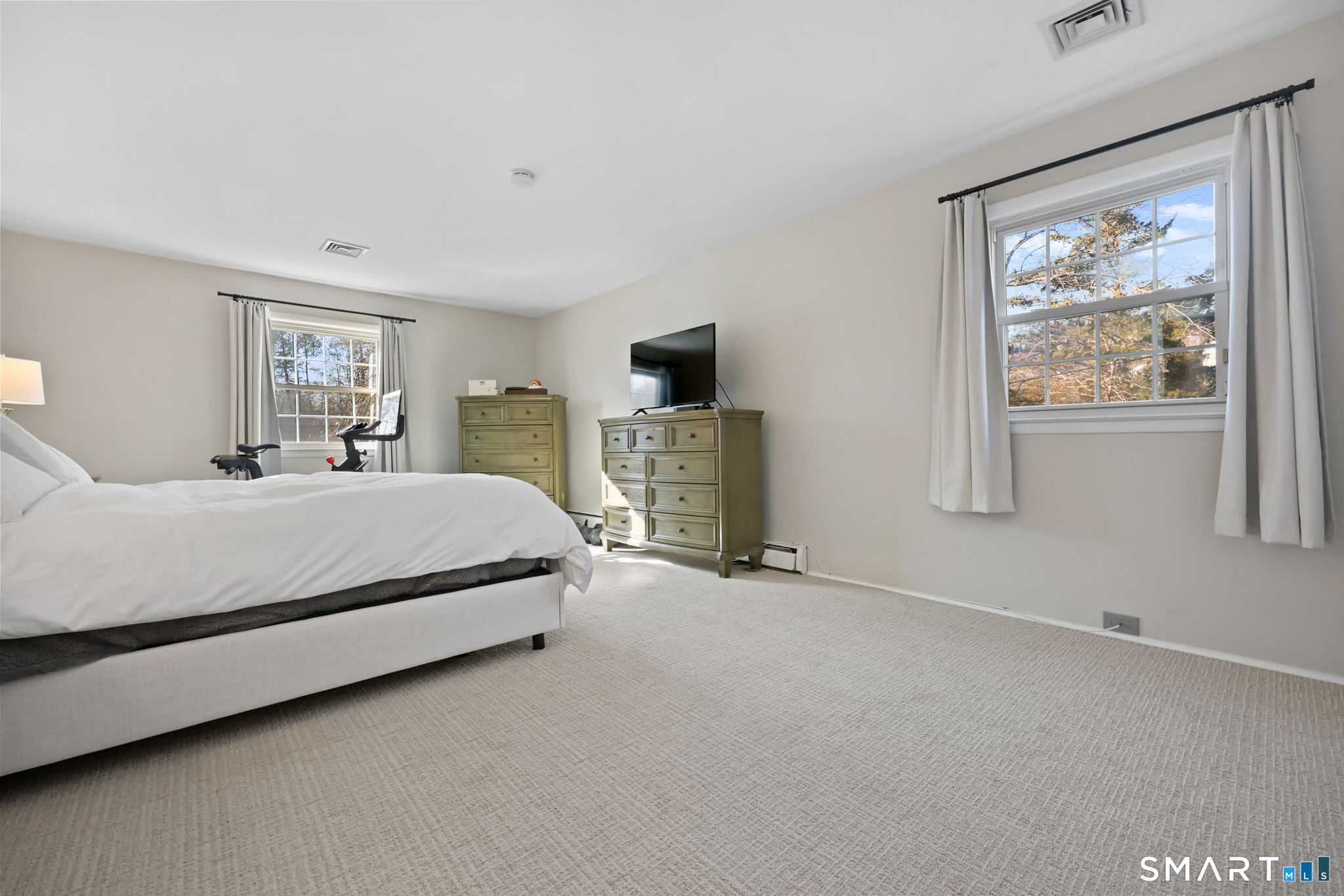 33 Purdy Road East Norwalk, CT 06850 - Photo 21 of 39 a bedroom with a large bed a painting on the wall and a window