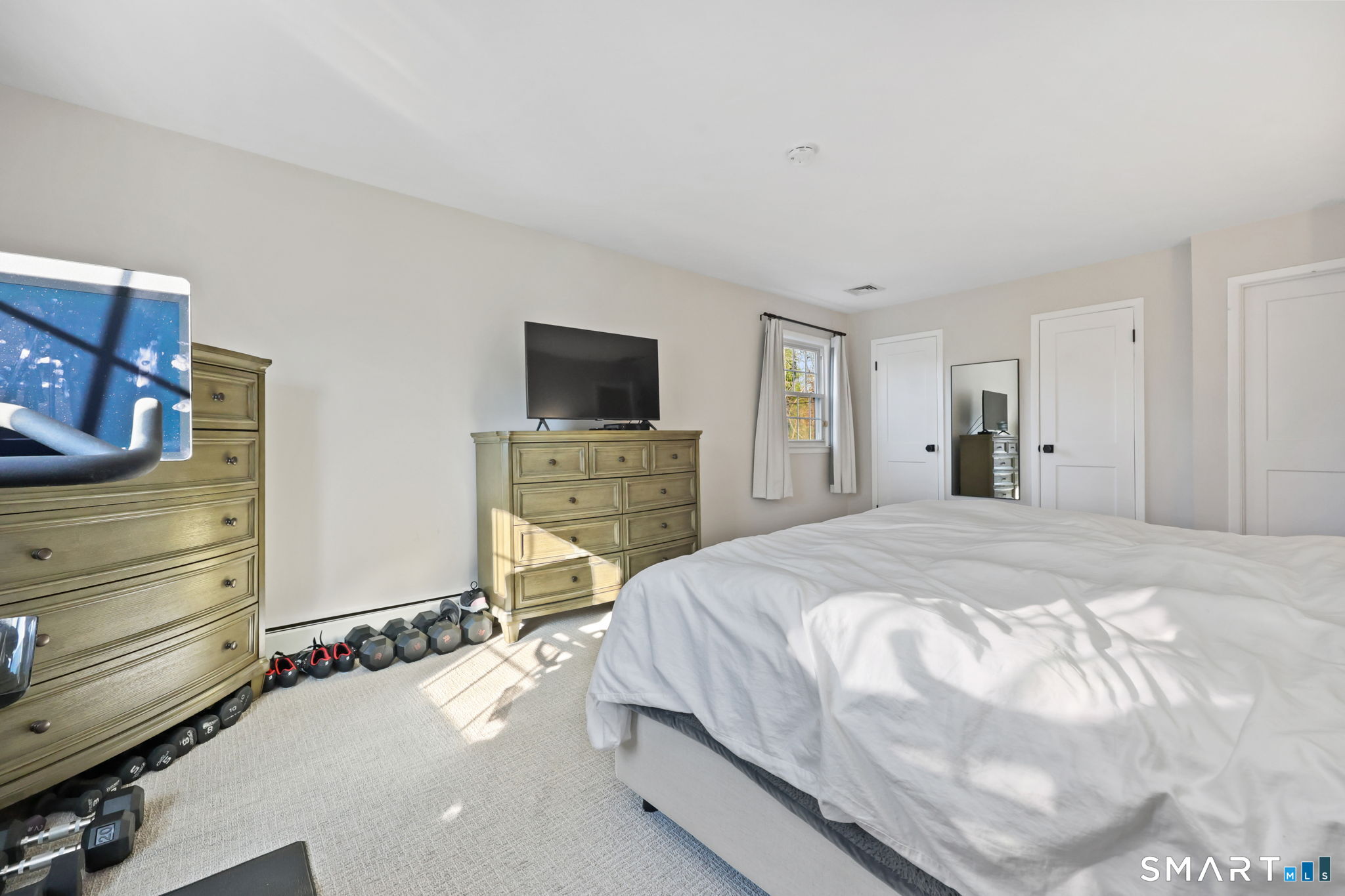 33 Purdy Road East Norwalk, CT 06850 - Photo 22 of 39 a spacious bedroom with a bed and a flat screen tv