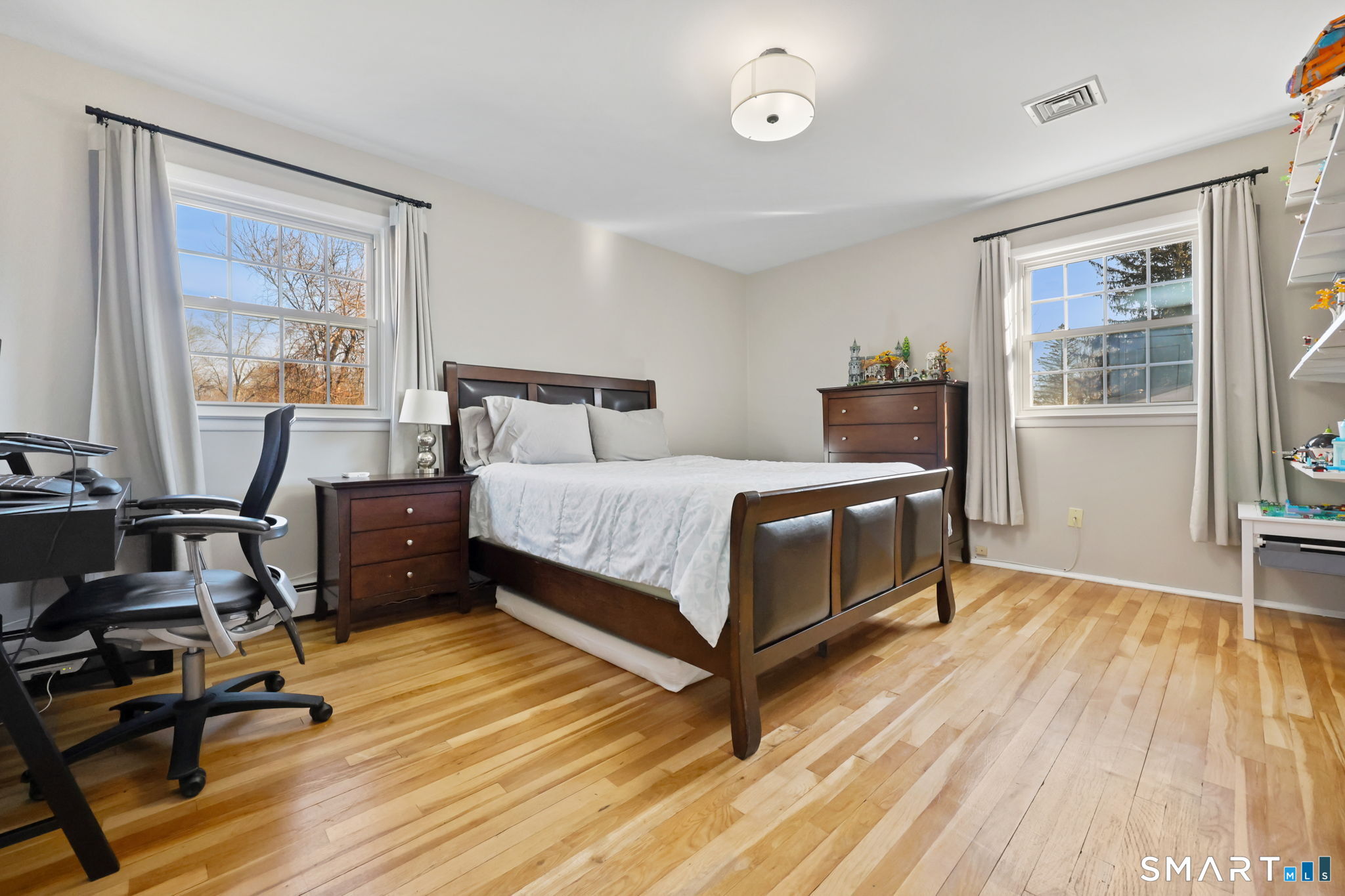 33 Purdy Road East Norwalk, CT 06850 - Photo 24 of 39 a bedroom with a bed and wooden floor