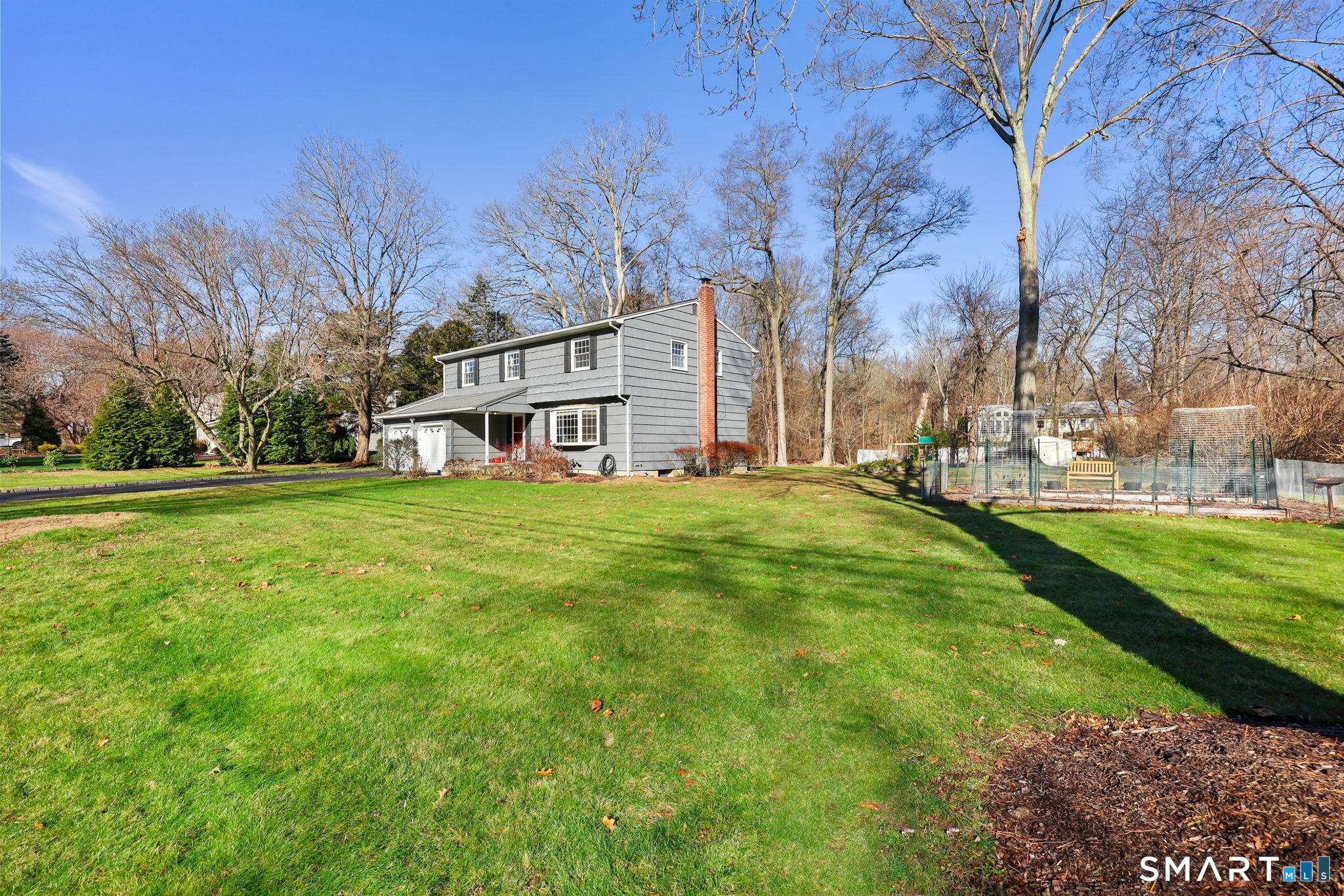 33 Purdy Road East Norwalk, CT 06850 - Photo 34 of 39 a view of a white house with a big yard and large trees