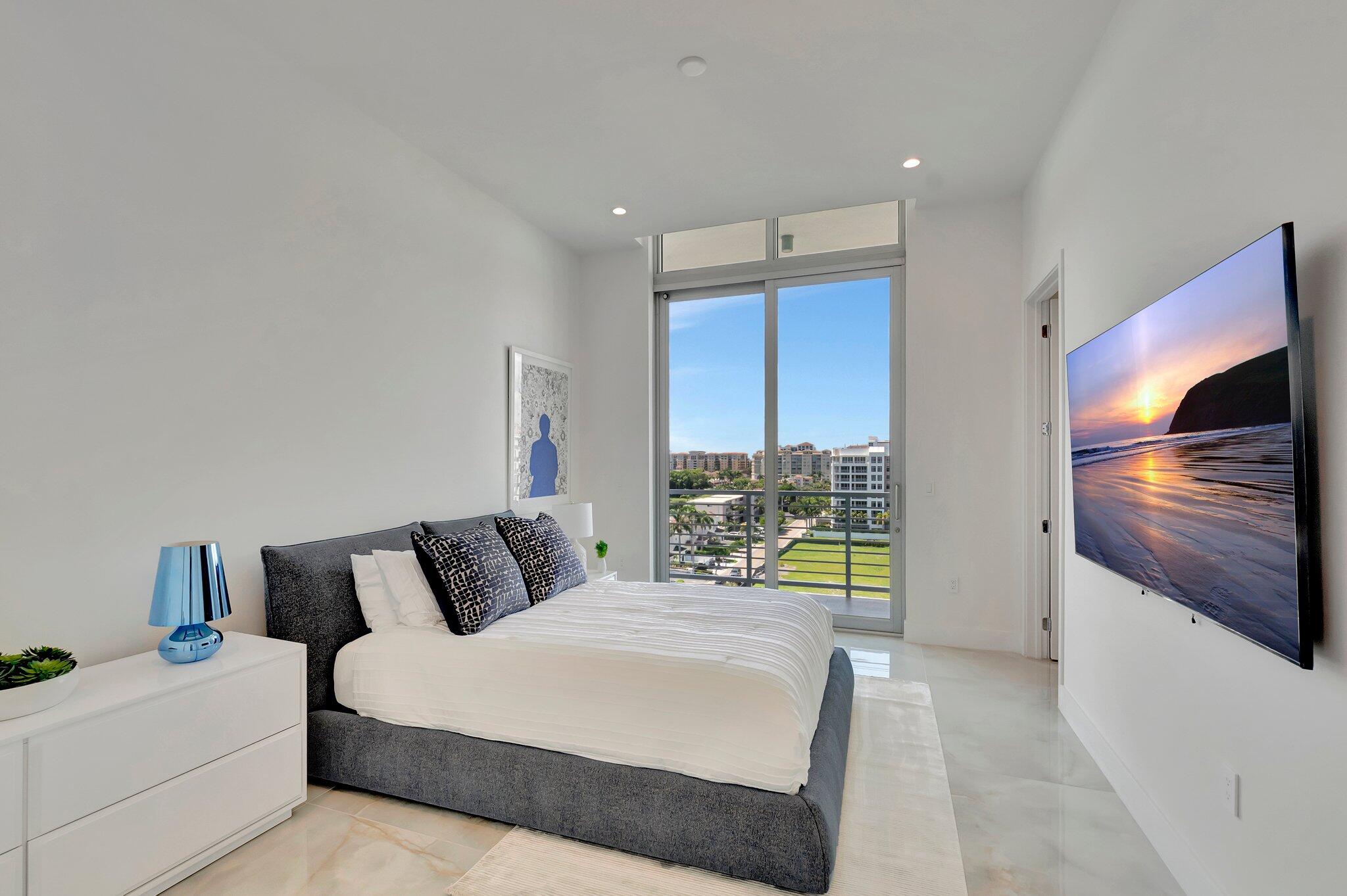 475 East Royal Palm Road, Unit PH 906 Boca Raton, FL 33432 - Photo 16 of 44 a bedroom with a bed and a television