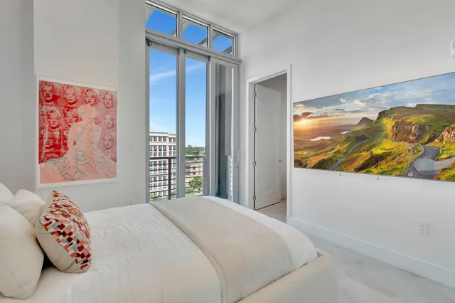 a bedroom with a bed and a painting on the wall