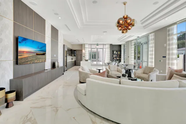 a large living room with stainless steel appliances kitchen island granite countertop furniture and a kitchen view