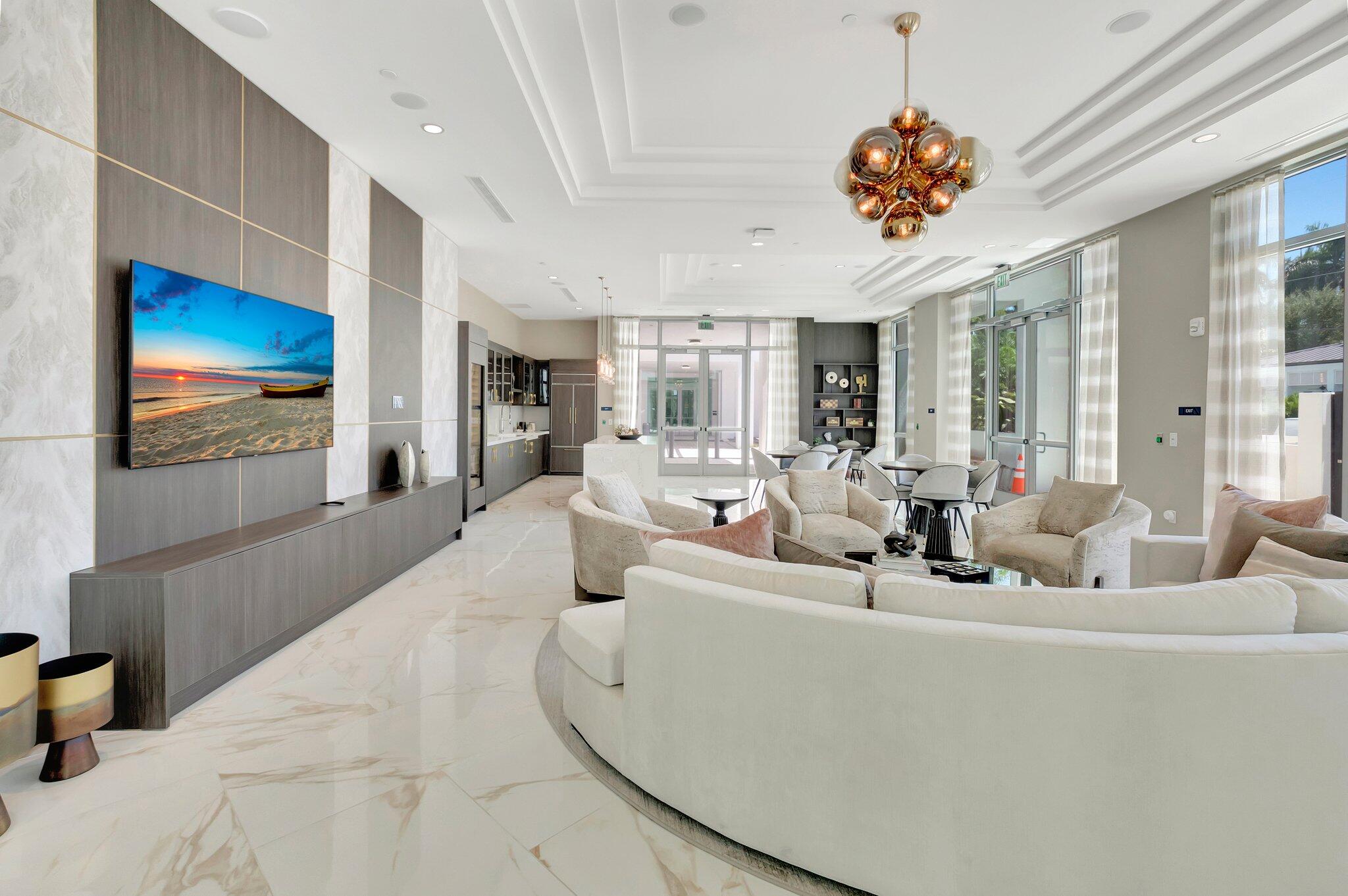 475 East Royal Palm Road, Unit PH 906 Boca Raton, FL 33432 - Photo 32 of 44 a living room with furniture chandelier and a flat screen tv