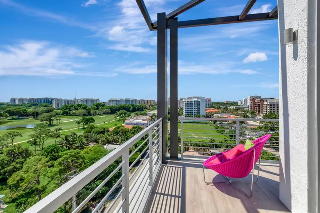 a view of a balcony with chair and wooden floor