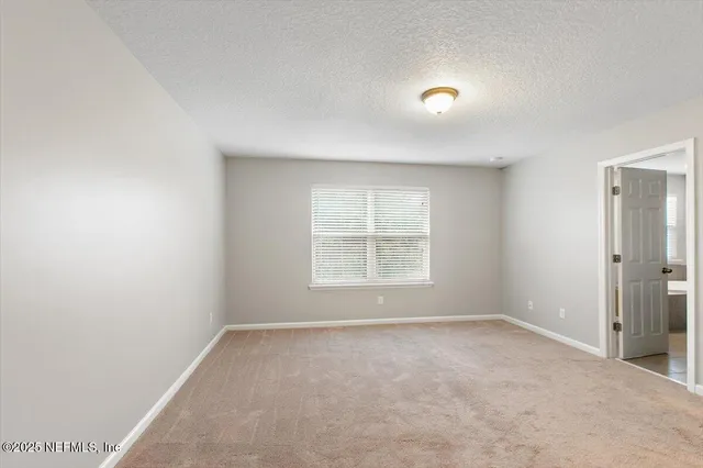 an empty room with a empty space and windows