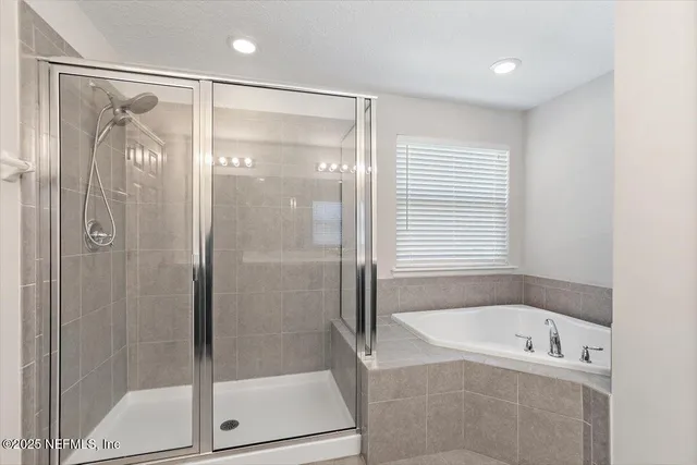 a bathroom with a bathtub and a shower