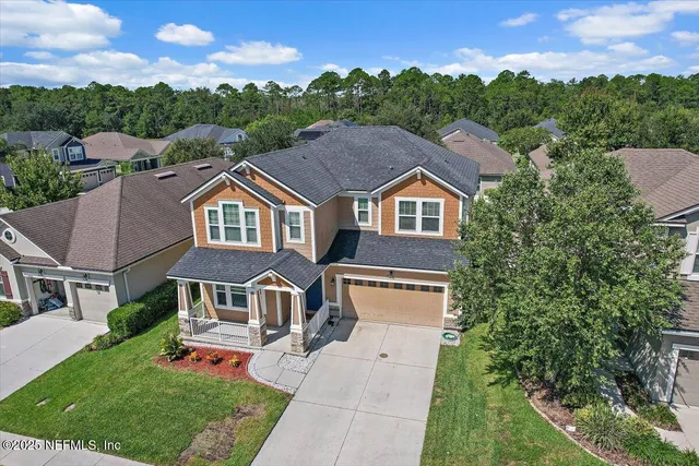 an aerial view of multiple houses with yard