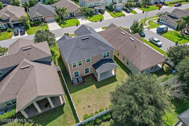 an aerial view of house with yard swimming pool and outdoor seating