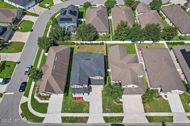 an aerial view of multiple house with yard
