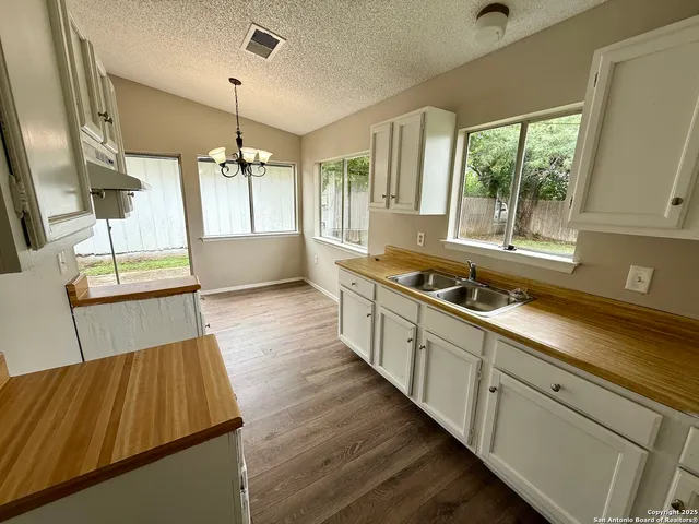 a kitchen with wooden cabinets and sink