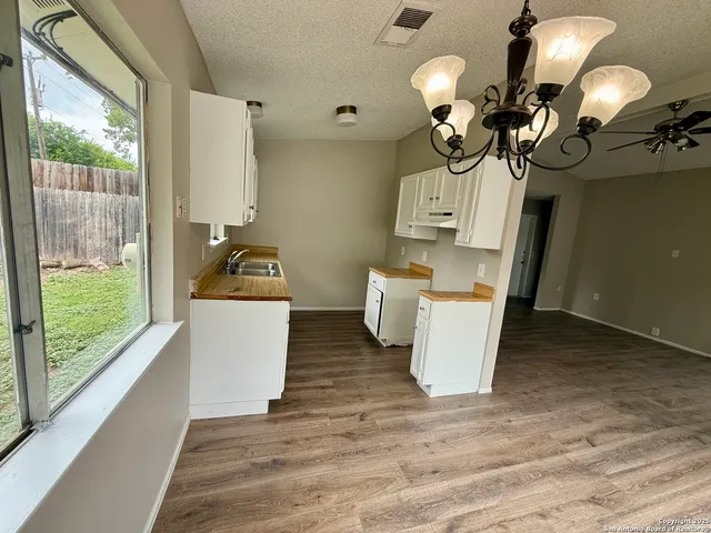 a bathroom with a sink a tub and a mirror