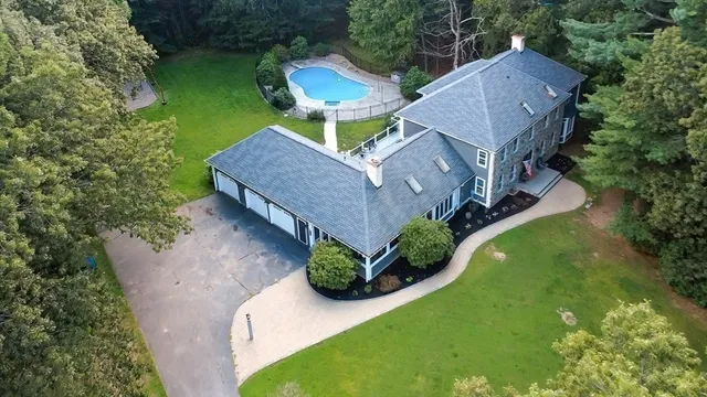 an aerial view of a house with garden space and street view