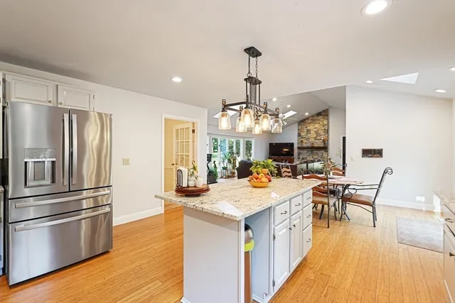 a large kitchen with a table chairs and refrigerator