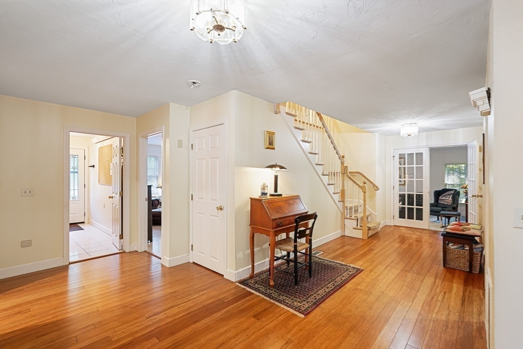 33 Woodstone Road Northborough, MA 01532 - Photo 15 of 42 a view of a livingroom with furniture wooden floor and a chandelier