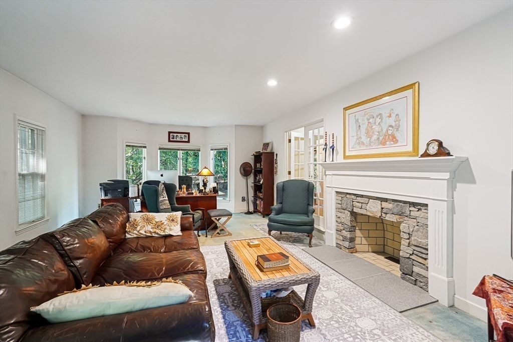 33 Woodstone Road Northborough, MA 01532 - Photo 19 of 42 a living room with furniture and a fireplace