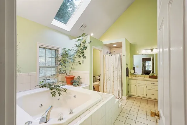 a bathroom with a tub sink and mirror