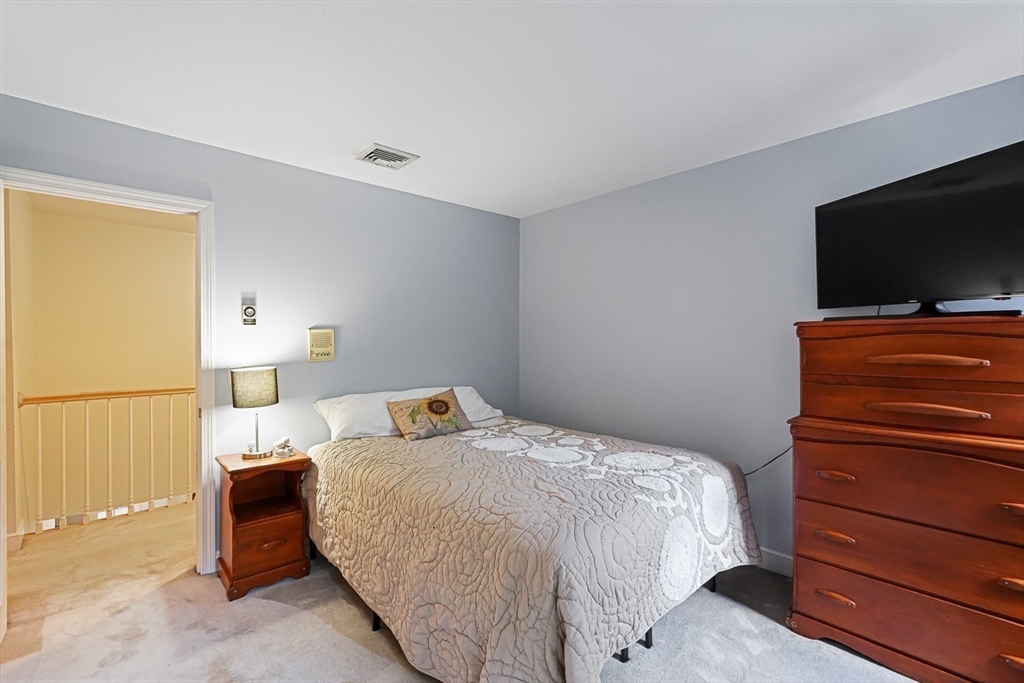 33 Woodstone Road Northborough, MA 01532 - Photo 28 of 42 a bedroom with a bed and a flat screen tv