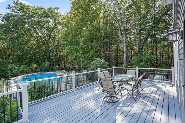 a view of a deck with two chairs and wooden floor