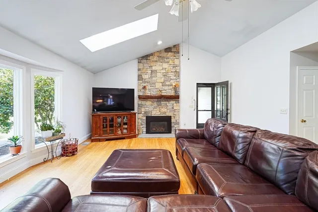 a living room with furniture fireplace and flat screen tv