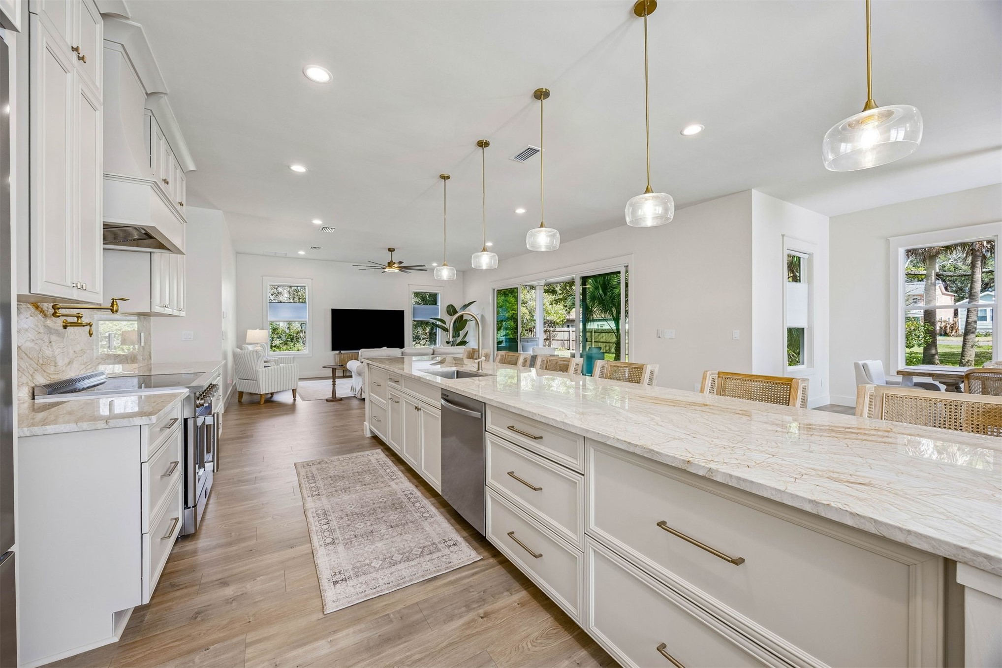 424 South 3rd Street Fernandina Beach, FL 32034 - Photo 5 of 38 a large kitchen with kitchen island a stove a sink a center island and wooden floor