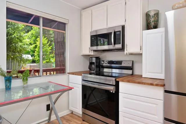 a kitchen with a stove a sink and a microwave