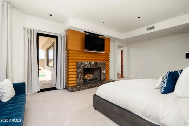 a view of a patio with table and chairs and a large tree