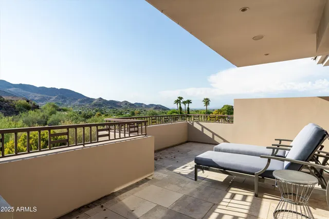 a balcony with furniture and a potted plant