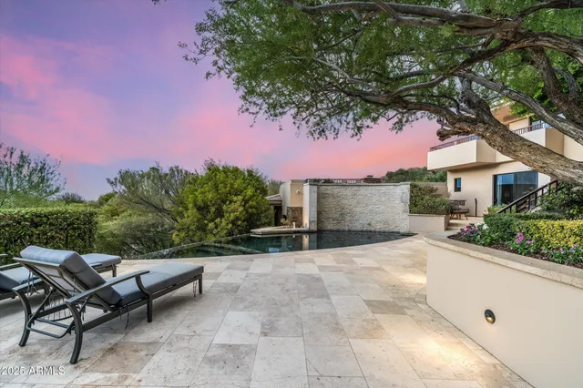 a living room with fireplace furniture and a large window