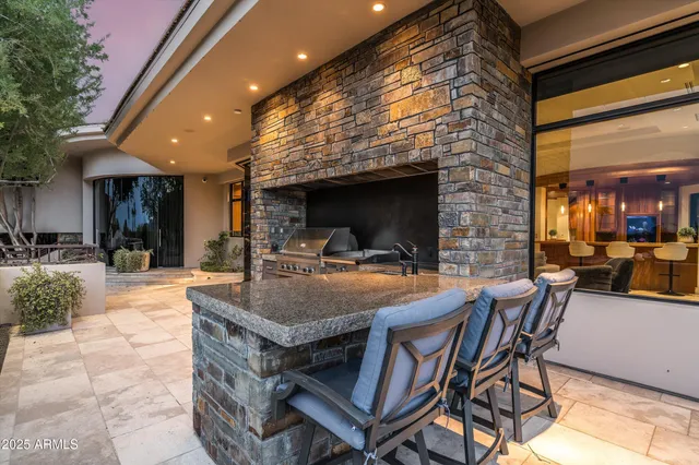 an aerial view of house with yard and mountain view in back