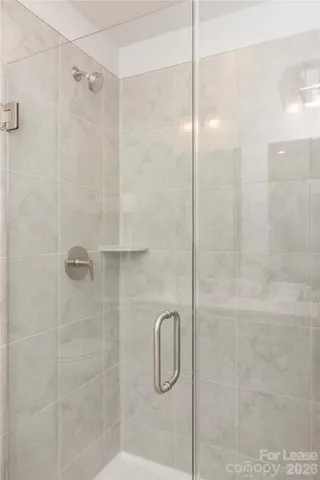 a bathroom with a glass shower door