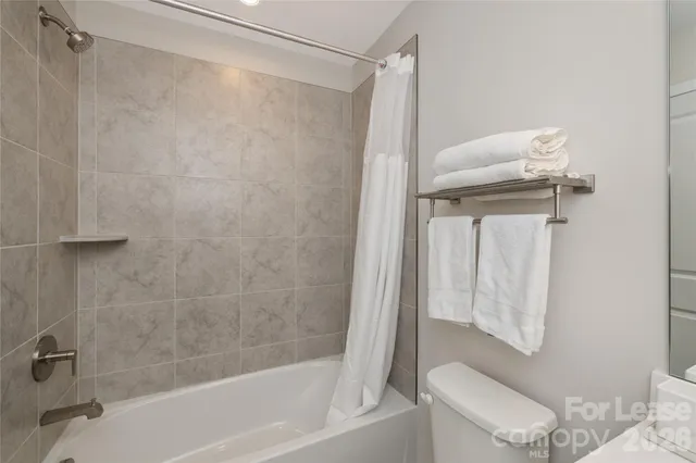 a bathroom with a shower and a toilet